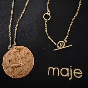 Maje gold tone Sagittarius toggle necklace.